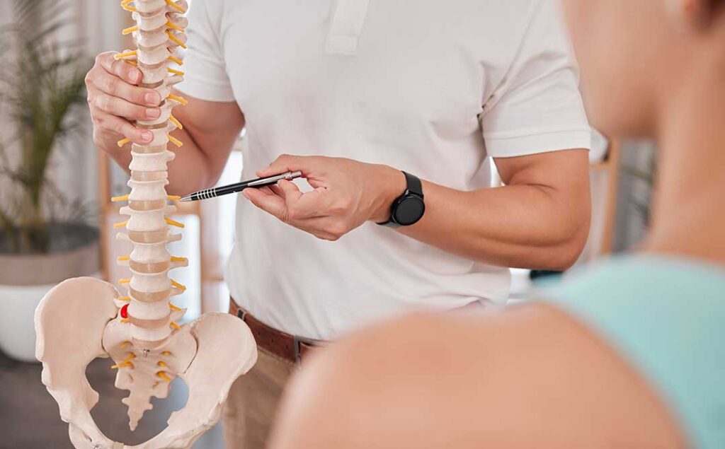 A chiropractor performing a gentle spinal adjustment on a patient in a bright, comfortable treatment room.
