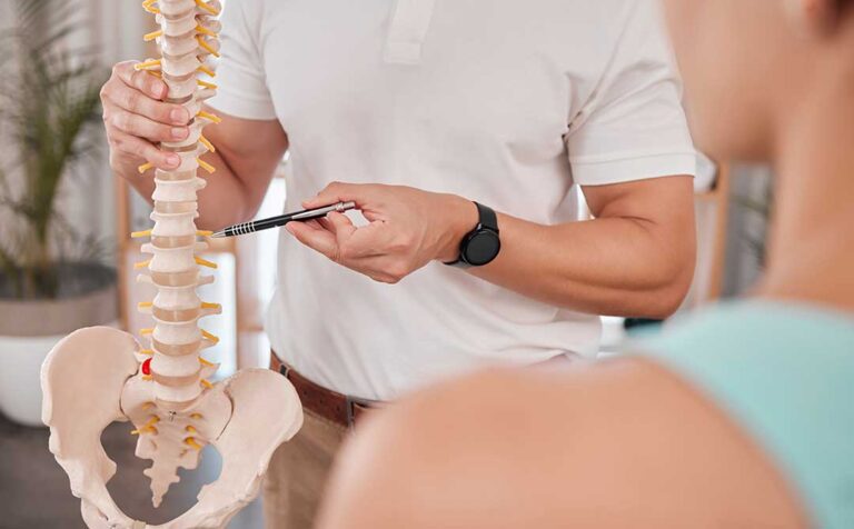 A chiropractor performing a gentle spinal adjustment on a patient in a bright, comfortable treatment room.